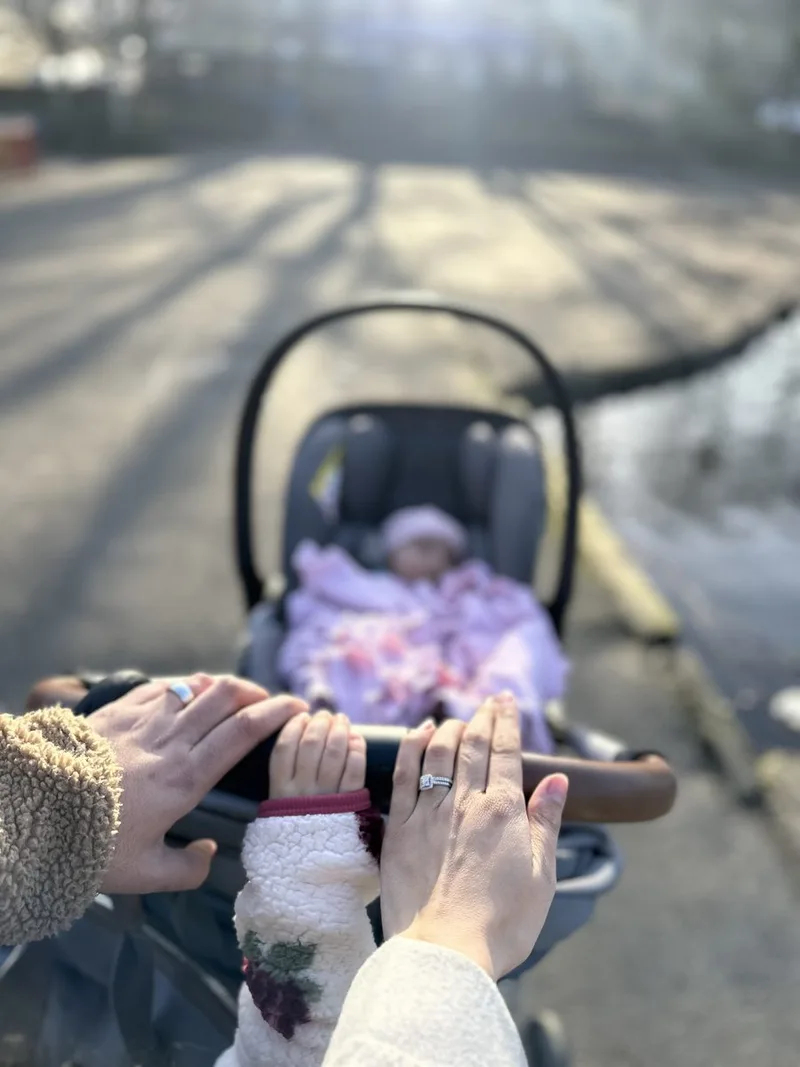The family’s hands resting together on Yusra’s pram