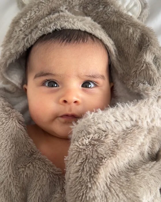 Yusra in a soft bear-eared hooded outfit